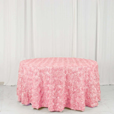 Pink rose-patterned tablecloth draped over a round table.