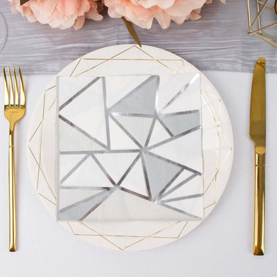 Geometric silver and white patterned napkin on a decorative plate