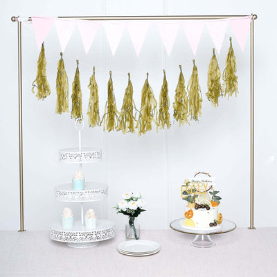 Party decoration setup with cake, stand, and festive garland.