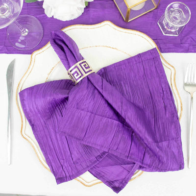 Purple textured napkin elegantly arranged on a decorative plate.