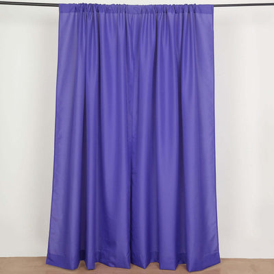 Purple sheer curtains hanging on a rod against a plain backdrop.