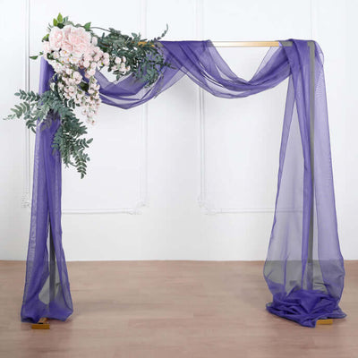 Purple draped fabric with floral arrangement for event decoration