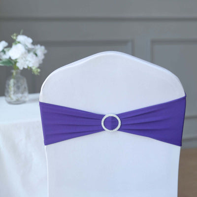 Purple chair sashes with a rhinestone buckle for elegant event decor.