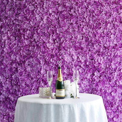 Champagne bottle and glasses on a table with a purple floral backdrop.