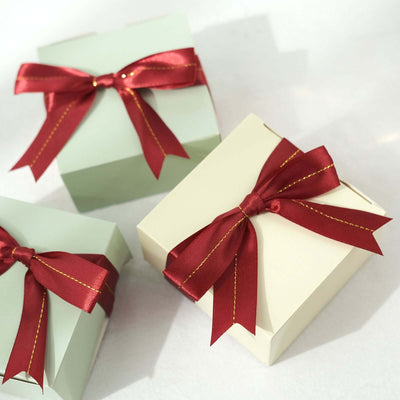 Gift boxes with red ribbons on a plain background