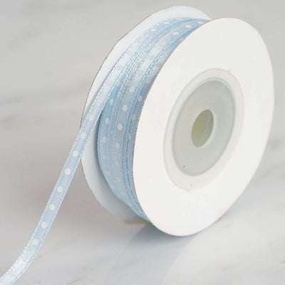 Light blue polka dot ribbon on a spool for crafting projects
