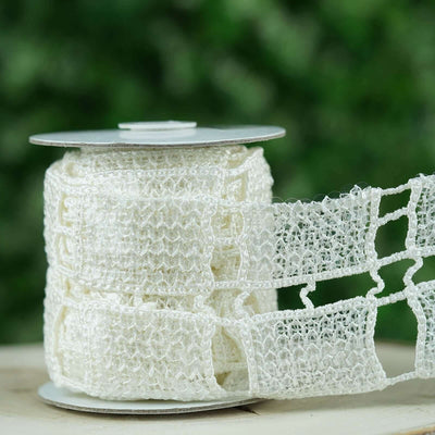 White lace ribbon on a spool for crafting and decoration.