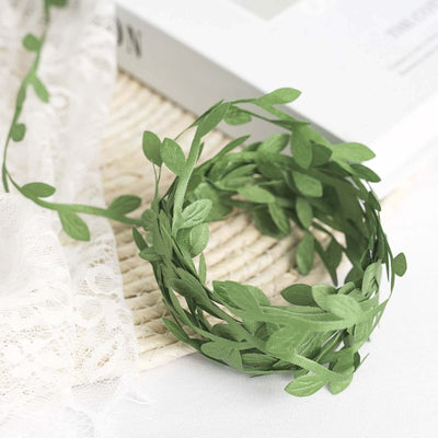Green leaf crown decoration on a textured surface.