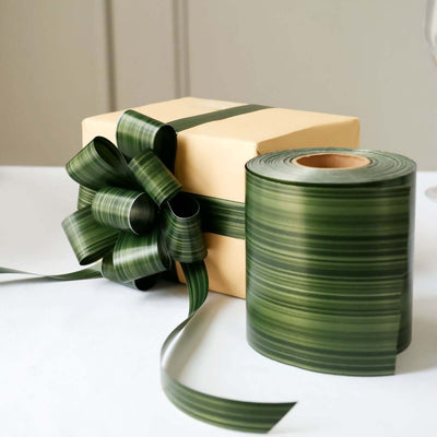 Green ribbon with bow on a gift box, showcasing elegant wrapping details.