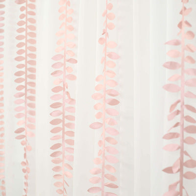 Pink leaf garland hanging decor on sheer fabric background.