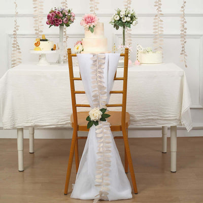 Elegant wedding table setup with floral decorations and a cake.