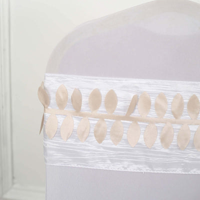 Beige leaf garland decoration on a white chair cover.