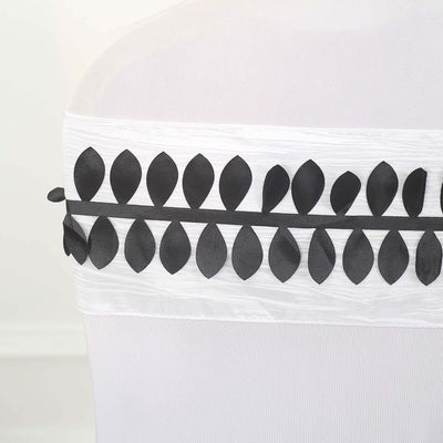 Black leaf design ribbon on a white chair cover