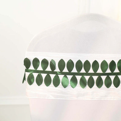 Green leaf ribbon decoration on a white chair cover