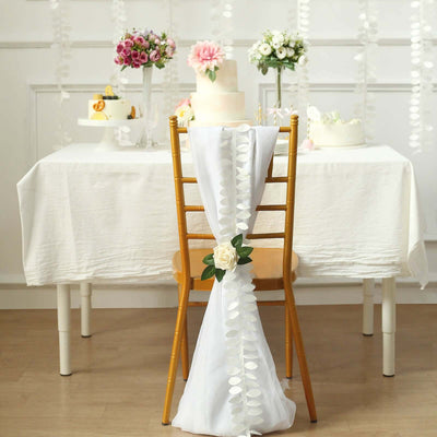 Elegant wedding decor with floral arrangements and a beautifully decorated cake.