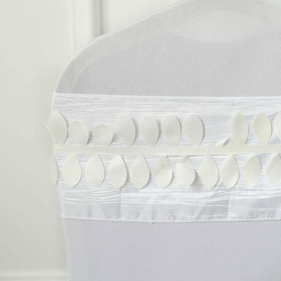 White chair cover with leaf-shaped embellishments on the top edge.
