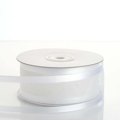 White satin ribbon roll on a plain white background