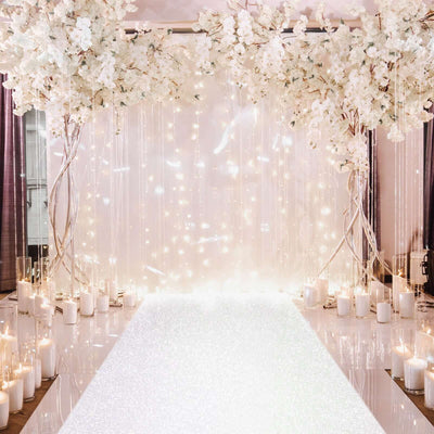 Elegant wedding backdrop with floral arrangements and candles for a romantic setting.