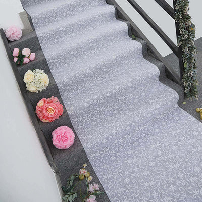 Floral patterned stair runner with roses on the steps.