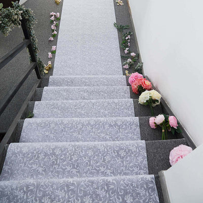 Decorative stair runner with floral design and scattered flowers on steps.