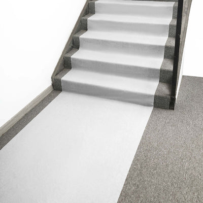 Staircase covered with protective white runner mat for easy movement