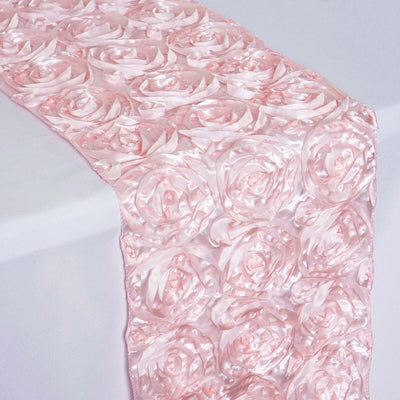 Pink satin rose table runner on a white table.