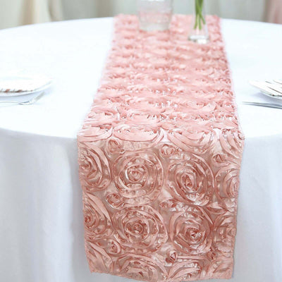 Pink rose-patterned table runner on a white tablecloth.