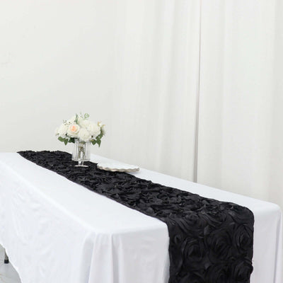 Black rose table runner on a white table with floral centerpiece.