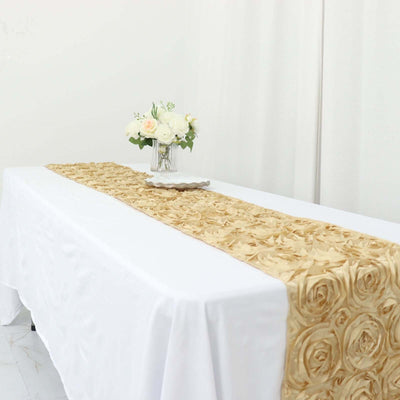 Gold rose pattern table runner on a white table with floral centerpiece.