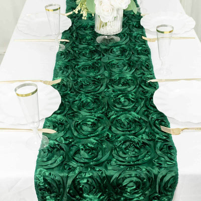 Green satin rose table runner on a white table setting with elegant glassware.