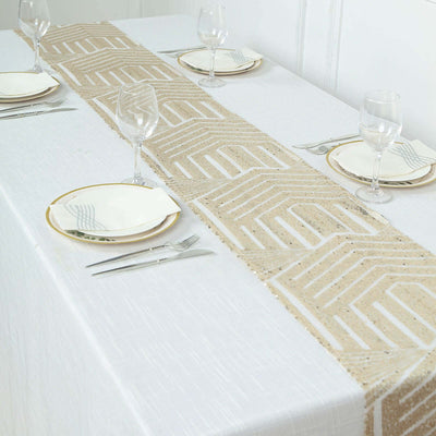 Elegant table runner on a white table setting with plates and glasses.