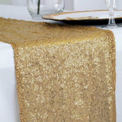 Gold sequin table runner draped elegantly over a white table.