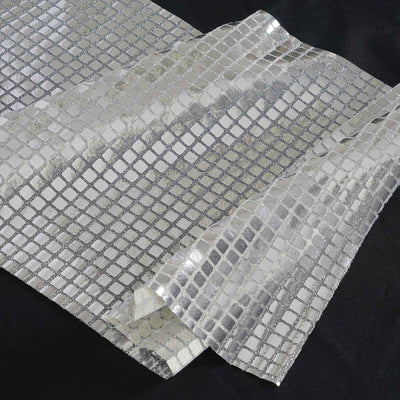 Metallic silver textured fabric with a grid pattern.