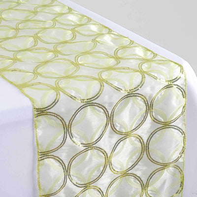 Green and gold circular pattern table runner on a white table.