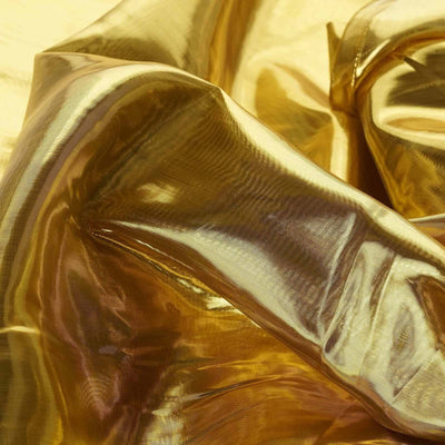 Shiny gold fabric draped elegantly with soft folds and reflections.