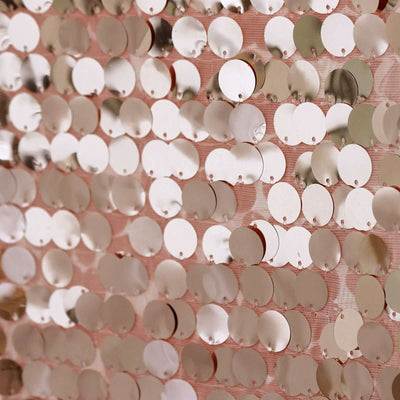 Rose gold sequin fabric close-up, shimmering circular sequins on mesh background.