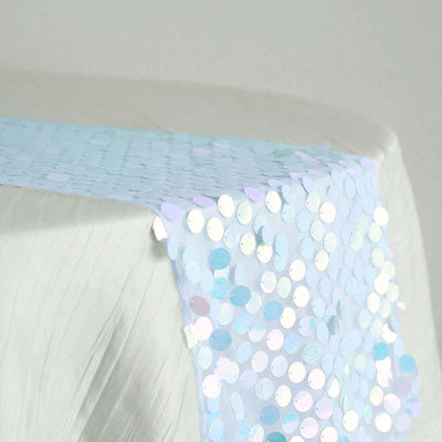 Iridescent sequin table runner in light blue draped over a white surface.