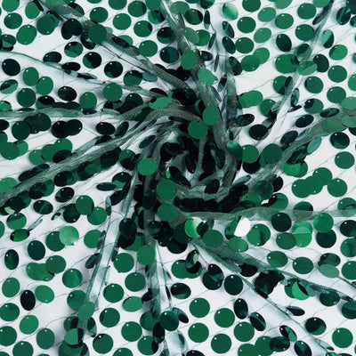 Green sequin fabric with circular embellishments and sheer overlay.