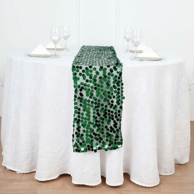 Green polka dot table runner on a white tablecloth with table settings.