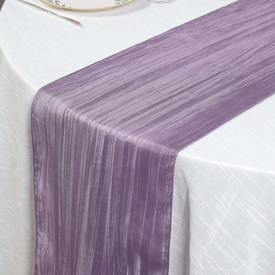Purple table runner on a white tablecloth.