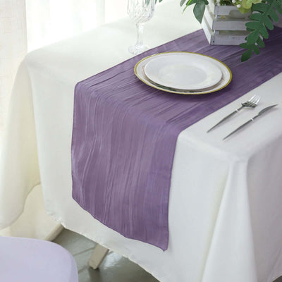 Purple table runner on a white table setting with plate and cutlery.