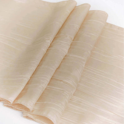 Soft beige fabric draped elegantly on a white background.