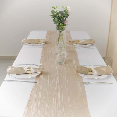 Elegant table setting with beige runner and floral centerpiece.