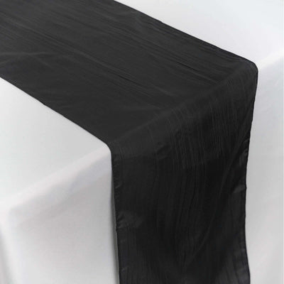 Black table runner with a textured finish on a white surface.