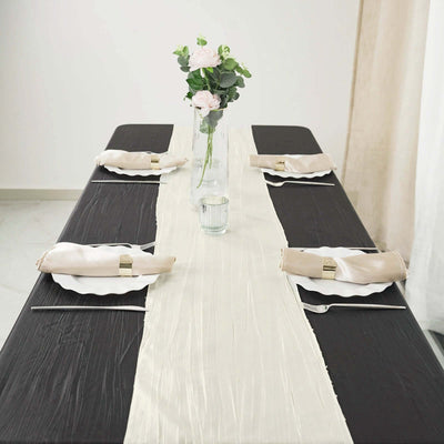 Elegant dining table set with a cream runner and fresh flowers.