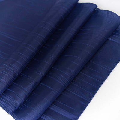 Navy blue satin fabric folded neatly on a white background.
