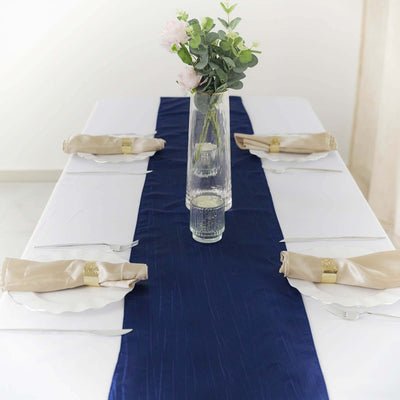 Elegant table setting with navy table runner and floral centerpiece.