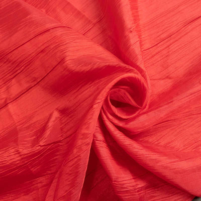 Textured red fabric in a swirl pattern.