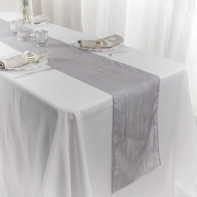 Elegant gray table runner on a white table setting for formal dining.