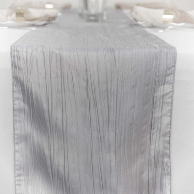 Elegant gray table runner with pleated texture on a dining table.